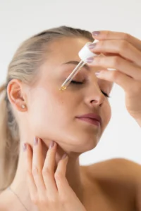 Applying facial serum with a dropper