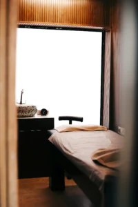 Treatment room with a bed beside a window
